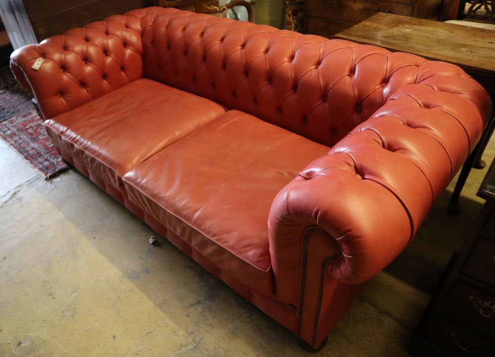 A Victorian style buttoned pale red leather Chesterfield settee, width 220cm depth 100cm height 74cm